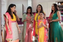Happy multigenerational Indian women in traditional saris — Stock Photo