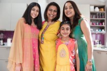 Portrait happy multigenerational Indian women in traditional saris — Stock Photo