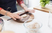 Close up Indian woman making naan  bread in kitchen — Stock Photo