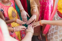 Femmes indiennes en saris joignant les mains en cercle — Photo de stock