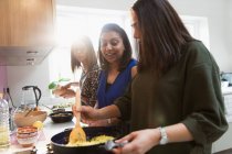 Indian women cooking food in kitchen — Stock Photo