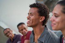 Young man hanging out with friends and laughing — Stock Photo