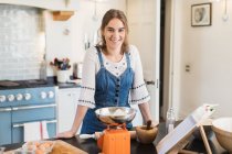 Портрет впевнена дівчина-підліток випічка на кухні — стокове фото