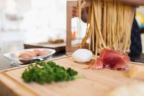Fresh pasta ingredients in kitchen — Stock Photo