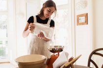 Woman measuring flour for baking in kitchen — Stock Photo