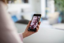 Happy women video chatting with smart phone — Stock Photo