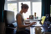 Mulher trabalhando em casa no laptop no escritório em casa — Fotografia de Stock