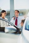 Business people talking at car — Stock Photo