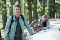 Smiling man with family in woods — Stock Photo