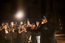 View of conductor leading orchestra — Stock Photo