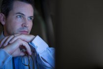 Pensive businessman working late — Stock Photo