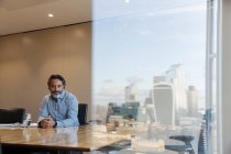 Portrait confident businessman in highrise conference room, London, UK — Stock Photo