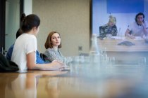 Business people video conferencing in conference room meeting — Stock Photo