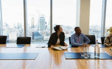 Business people listening in highrise conference room meeting — Stock Photo