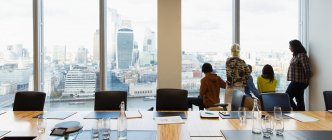 Business people looking out highrise office window, London, UK — Stock Photo