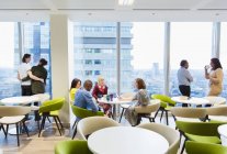 Business people in highrise office cafeteria — Stock Photo