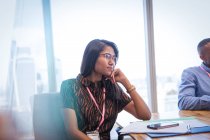 Attentive businesswoman listening in conference room meeting — Stock Photo