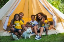 Портрет счастливая семья с собаками в палатке кемпинга — стоковое фото