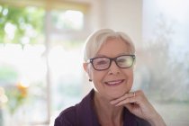 Portrait happy confident senior woman in eyeglasses — Stock Photo