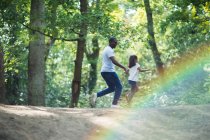 Feliz pai e filha correndo em trilha em florestas de verão — Fotografia de Stock