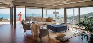Woman on luxury home showcase patio with scenic ocean view — Fotografia de Stock