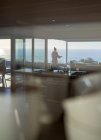 Woman on luxury balcony with scenic ocean view — Stock Photo