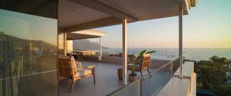 Luxury home showcase exterior patio with sunset ocean view — Stock Photo