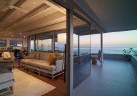 Роскошная гостиная с витриной и балкон с живописным видом на океан — стоковое фото
