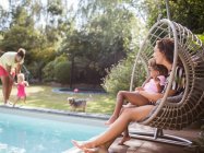 Сім'я грає і відпочиває в сонячному літньому басейні — стокове фото