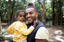 Portrait happy father and daughter in woods — Stock Photo