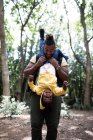 Playful father holding daughter upside down on hike in woods — Stock Photo