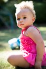 Portrait cute toddler girl in sunny park grass — Stock Photo