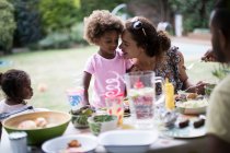 Mother and daughter enjoying backyard barbecue at patio table — Stock Photo
