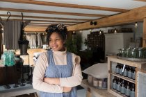 Portrait confident female shop owner with arms crossed — Stock Photo