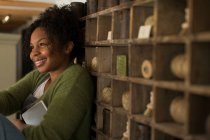 Happy female shop owner at vintage display — Stock Photo