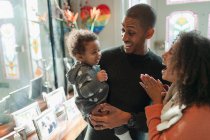 Genitori felici con bambina a casa — Foto stock