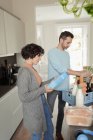 Couple unloading groceries in kitchen — Stock Photo