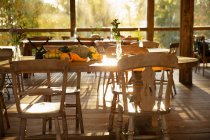 Autumn pumpkins and gourds on table in sunny rustic restaurant — Stock Photo