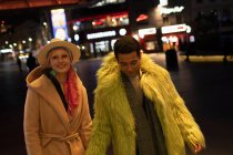 Portrait fashionable couple on city street at night — Stock Photo