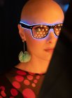 Close up retrato mulher elegante com a cabeça raspada em óculos de néon — Fotografia de Stock
