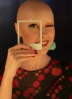 Portrait fashionable woman with shaved head and polaroid cut out — Stock Photo