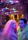 Portrait cool fashionable couple under neon lights — Stock Photo