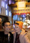 Portrait happy stylish couple at Chinatown Gate at night, London, UK — Stock Photo