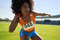 Focused female track and field athlete throwing shot put — Stock Photo