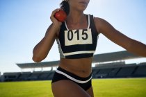Close up female track and field athlete throwing shot put — Stock Photo