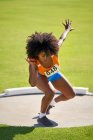Female track and field athlete throwing shot put — Stock Photo