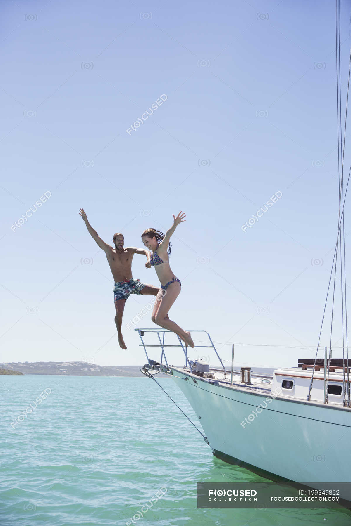 Couple Jumping Off Boat Into Water Yacht Transportation Stock
