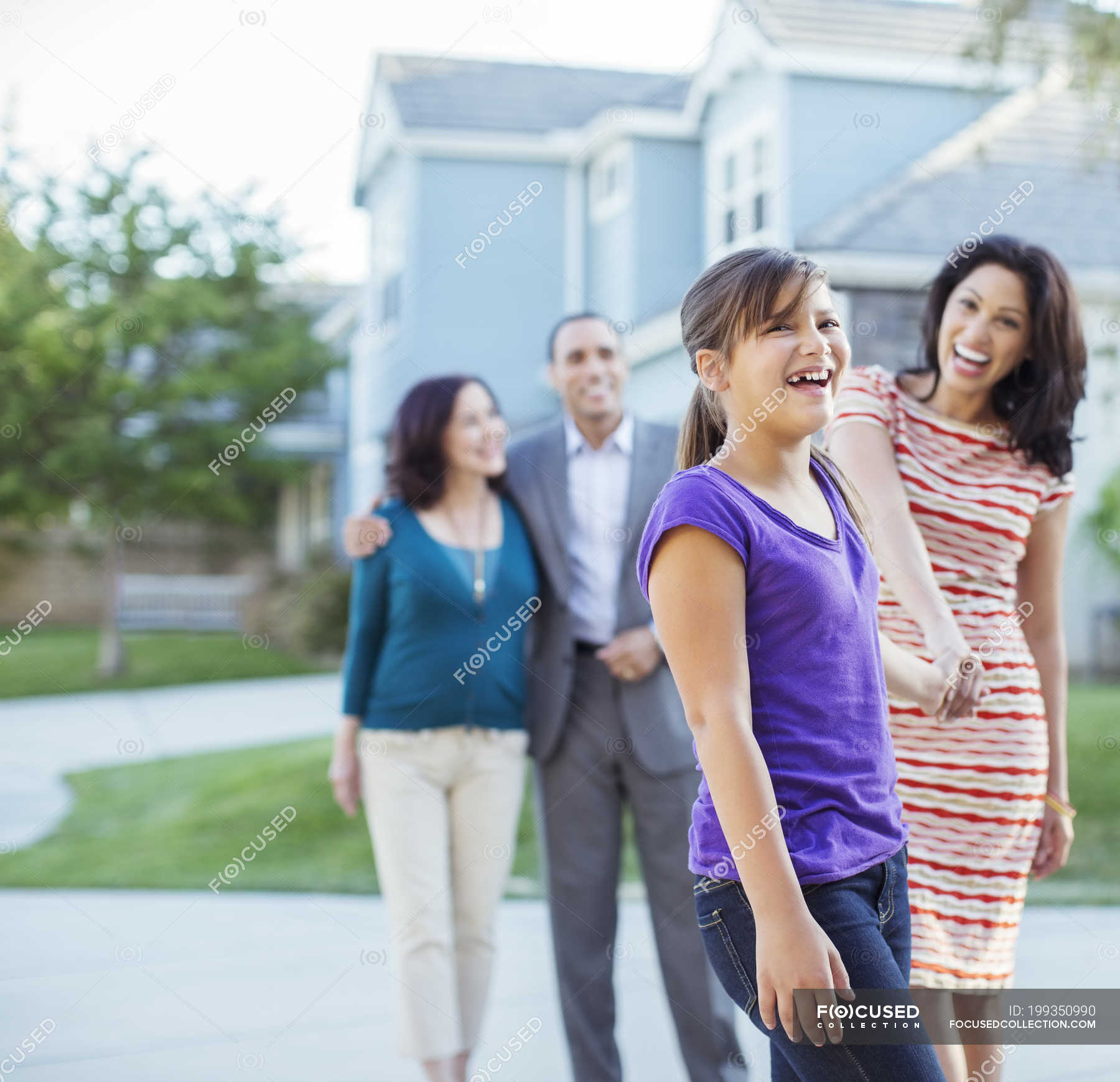 Multi-generation family walking outside house — grandfather, Mixed Race ...