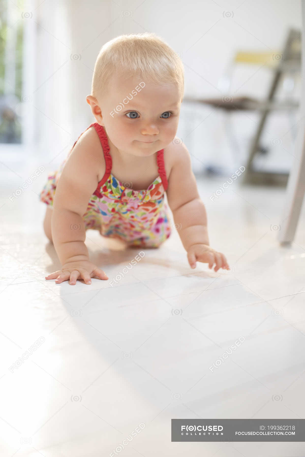 Baby Girl Crawling On Floor Focus On Foreground Three Quarter
