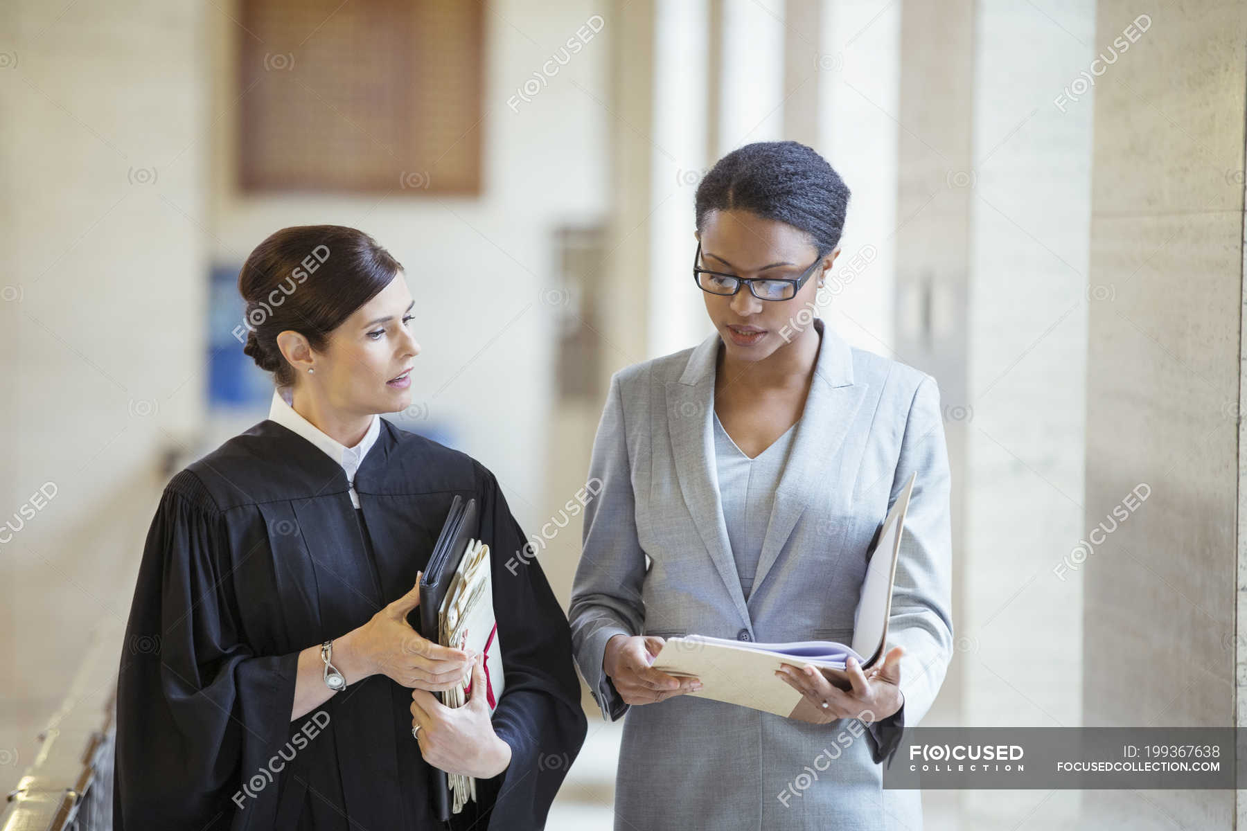 Judge and lawyer talking in courthouse — justice, togetherness - Stock ...